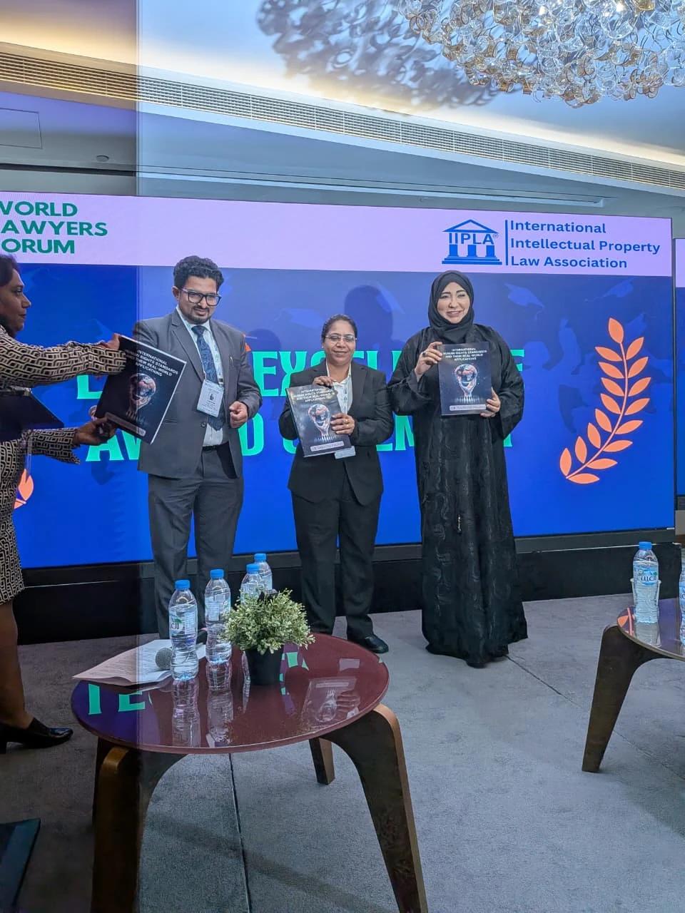 Participants holding awards together at a past IIPLA ceremony.