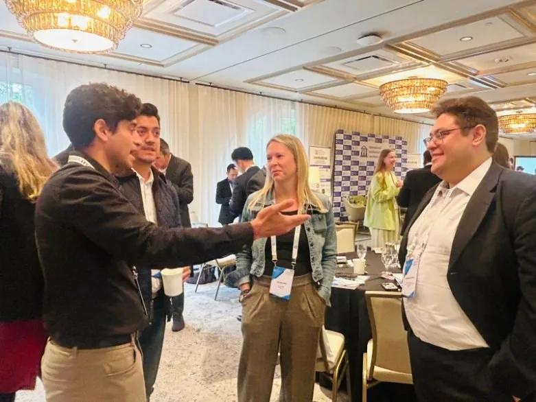 IIPLA USA 2025 participants talking together around a table during a networking gathering
